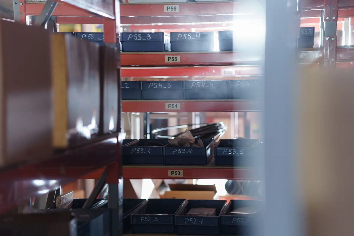 Numbered storage bins arranged on warehouse shelving.